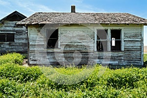 Broken windows on the side of an abandoned farmhouse in eastern Washington, USA