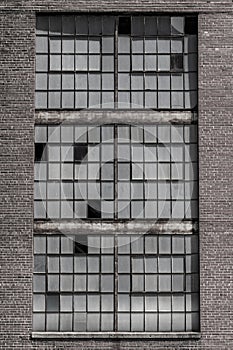 Broken windows and worn exterior of an abandoned coal power plant. Coal power plants are being phased out