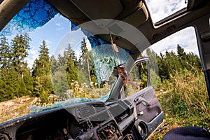 Broken windshield on abandoned car close up shot