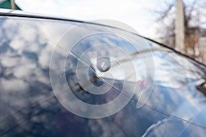 Broken windshield with big crack through the glass, damaged car