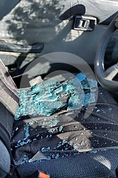 The broken windshield of the car, fragments lie on the seat. Concepts- accident, car insurance, traffic accident.