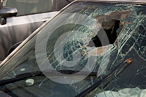 Broken windshield with hole of the car involved in an accident