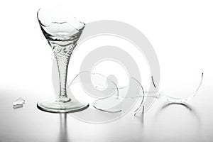 Broken wine glass and shattered glass isolated on white