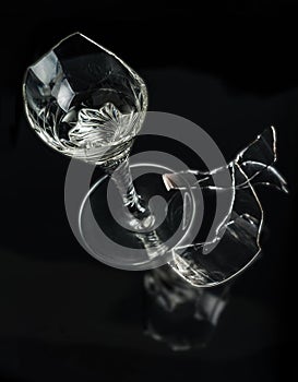 Broken wine glass and shattered glass isolated on black background
