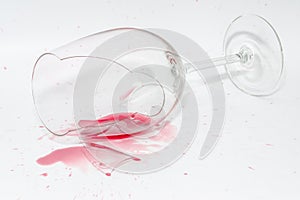 Broken wineglass with spilled splash of red wine