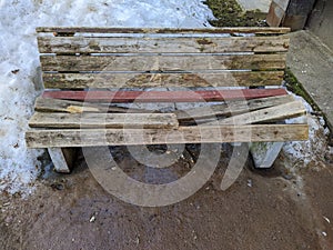 broken wooden bench in early spring.