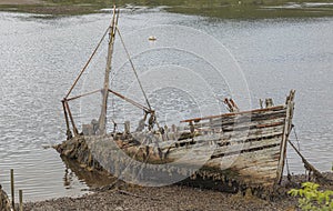 Broken wooden fishing boat washed up