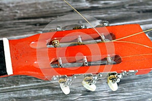 A broken wooden old classic guitar with damaged strings chords, shattered musical instrument, unattached damaged guitar with cut