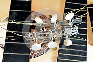 A broken wooden old classic guitar with damaged strings chords, shattered musical instrument, unattached damaged guitar with cut