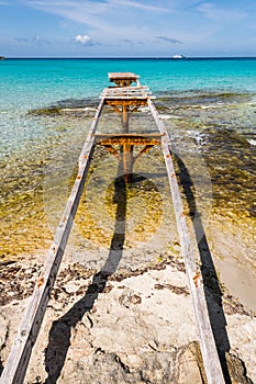 Broken wooden pier Illetes beach Formentera island