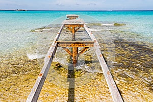 Broken wooden pier Illetes beach Formentera island