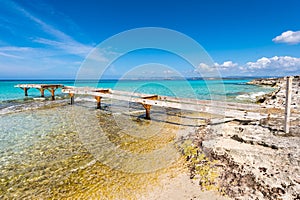 Broken wooden pier Illetes beach Formentera island