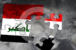 broken wooden puzzle with the flag of Iraq on a gray map of the Middle East photo