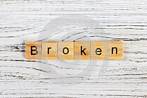 BROKEN word made with wooden blocks concept