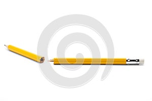 Broken yellow pencil on a white background with fragments around the middle of plain paper