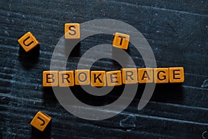 Brokerage on wooden cubes. On table background