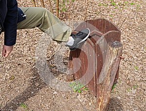 Broking Trash Bin by Vandal, Damaging Wooden Trash Can