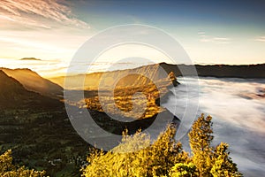 Bromo village on the mountain cliff with sunrise sky background and morning fog landscape at Indonesia Bromo national park