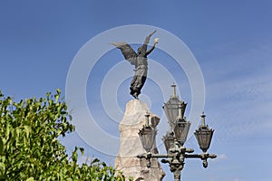 bronce angel sculpture of russalka monument with blue sky at background photo