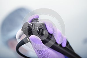 Bronchoscope in the doctor`s hand during the procedure