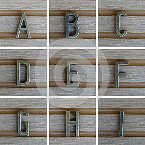 Bronz alphabet letter on wooden background. A, B, C, D, E, F, G, H, I Set 1 from 3, search others in portfolio photo