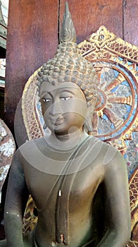 Bronz Buddha image and wheel of Dhama photo