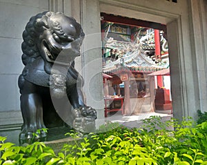 Bronz Chinese lion guarding Chinese shrine photo