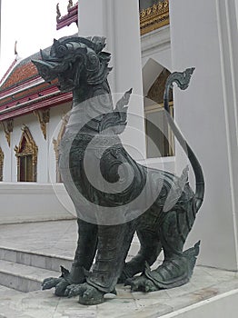 Bronz singha guarding the temple entrance