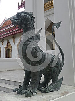 Bronz singha guarding the temple entrance photo