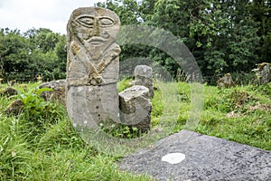 This is a bronze age stone carviing with two faces,called Janus, located In Caldragh Cemetery on Boa Island, Lower Lough