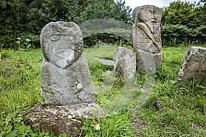 This is a bronze age stone carviing with two faces,called Janus, located In Caldragh Cemetery on Boa Island, Lower Lough