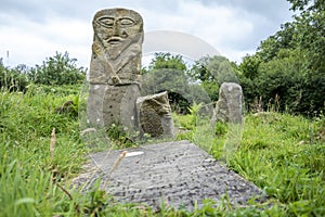 This is a bronze age stone carviing with two faces,called Janus, located In Caldragh Cemetery on Boa Island, Lower Lough