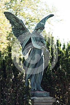 bronze angel on tomb in cemetery