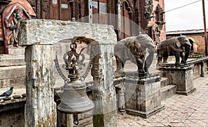 Bronze bell and stone elephants in the Changu Narayan temple