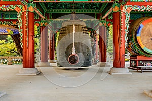 Bronze bell and striker in Buddhist pavilion