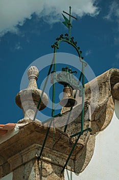 Bronze bell on top of stone decoration in baroque style