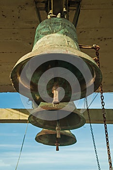 Bronze bells with chain in a country church photo