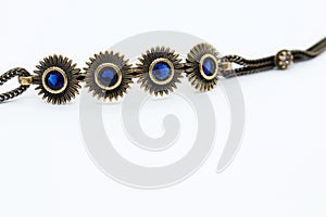 Bronze bracelet with blue crystals, white background