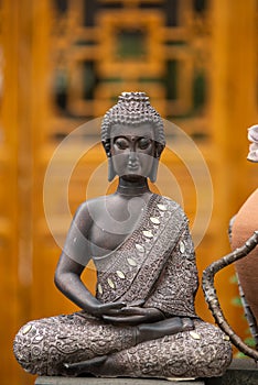 Bronze buddha statue against temple facade