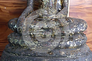 Bronze Buddha statue with gold leaf, old, in Thai temple, belief in Buddhism