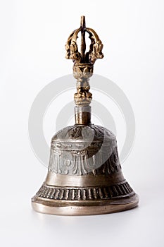 A bronze buddhist hand bell isolated over a white background