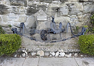 Bronze chain and anchor on a stone memorial to the fallen sailors of Cortona in Cortona, Italy.