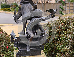 Bronze of Children playing with Birds in Elena`s Childrens Park at Christmas in University Park, Texas