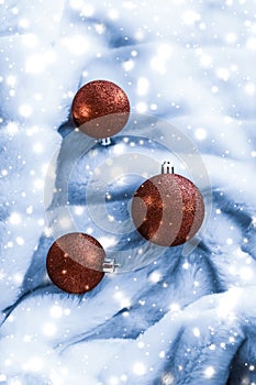 Bronze Christmas baubles on blue fluffy fur with shiny snow glitter, luxury winter holiday design background