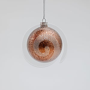 Bronze Christmas tree ball covered with sparkles photo