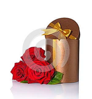 Bronze classic shiny round gift box with golden satin bow and bouquet of roses