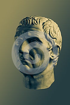 Bronze color gypsum copy of ancient statue of Guy Julius Caesar Octavian Augustus head for artists isolated on brass
