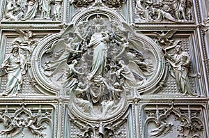 Bronze door of the Milan Cathedral, Italy photo