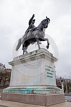 Bronze equestrian statue of General Dufour in uniform raising his right arm in Geneva, Switzerland