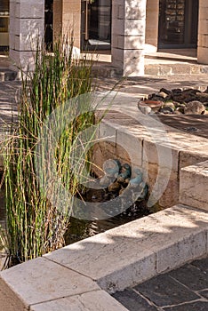 Bronze fish fountain in the courtyard of Tabgha or The Church of the Multiplication of the Loaves and Fishes